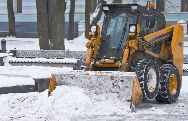 tractor clears snow on city streets